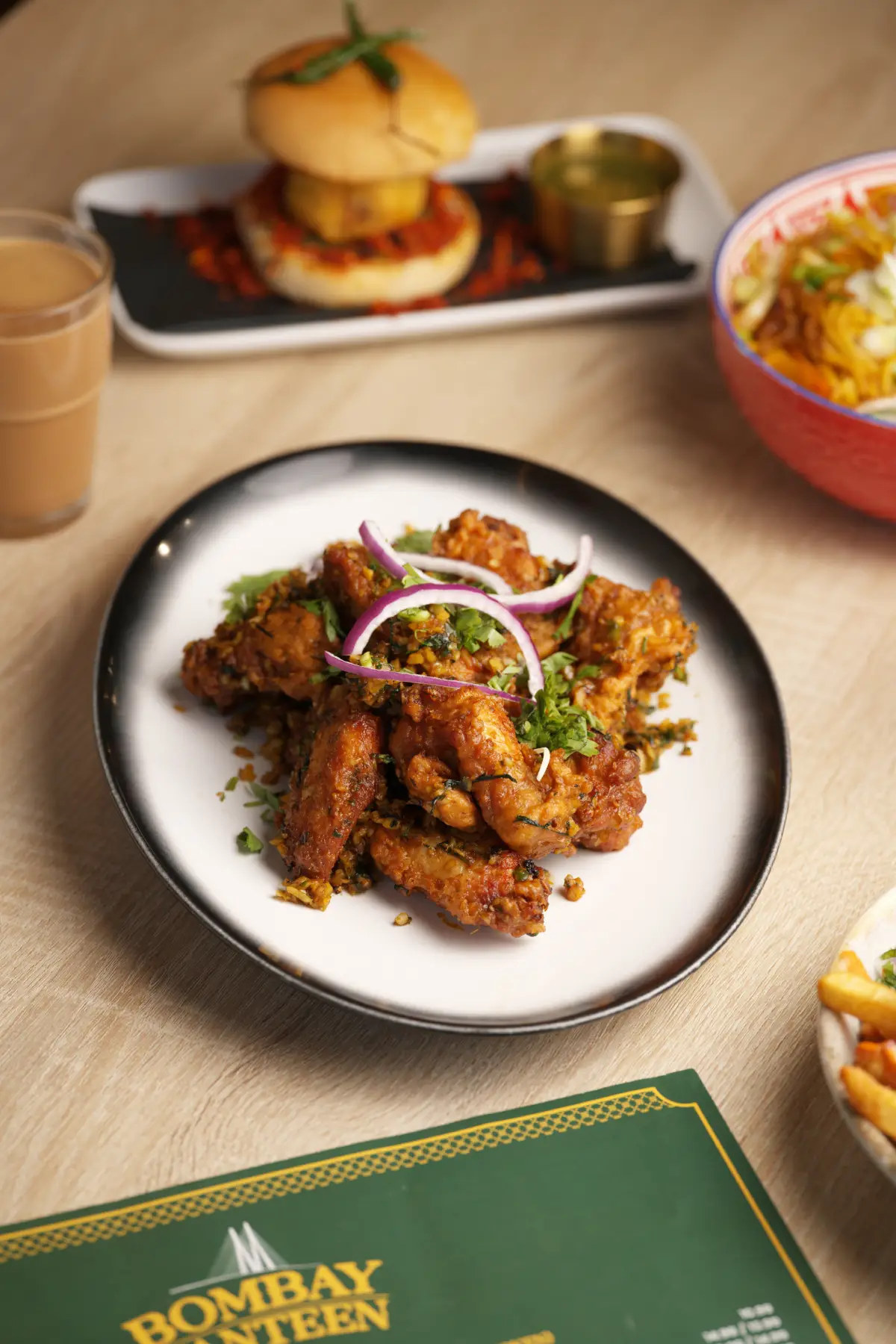 Crispy Indian fried appetizer garnished with red onions and fresh cilantro