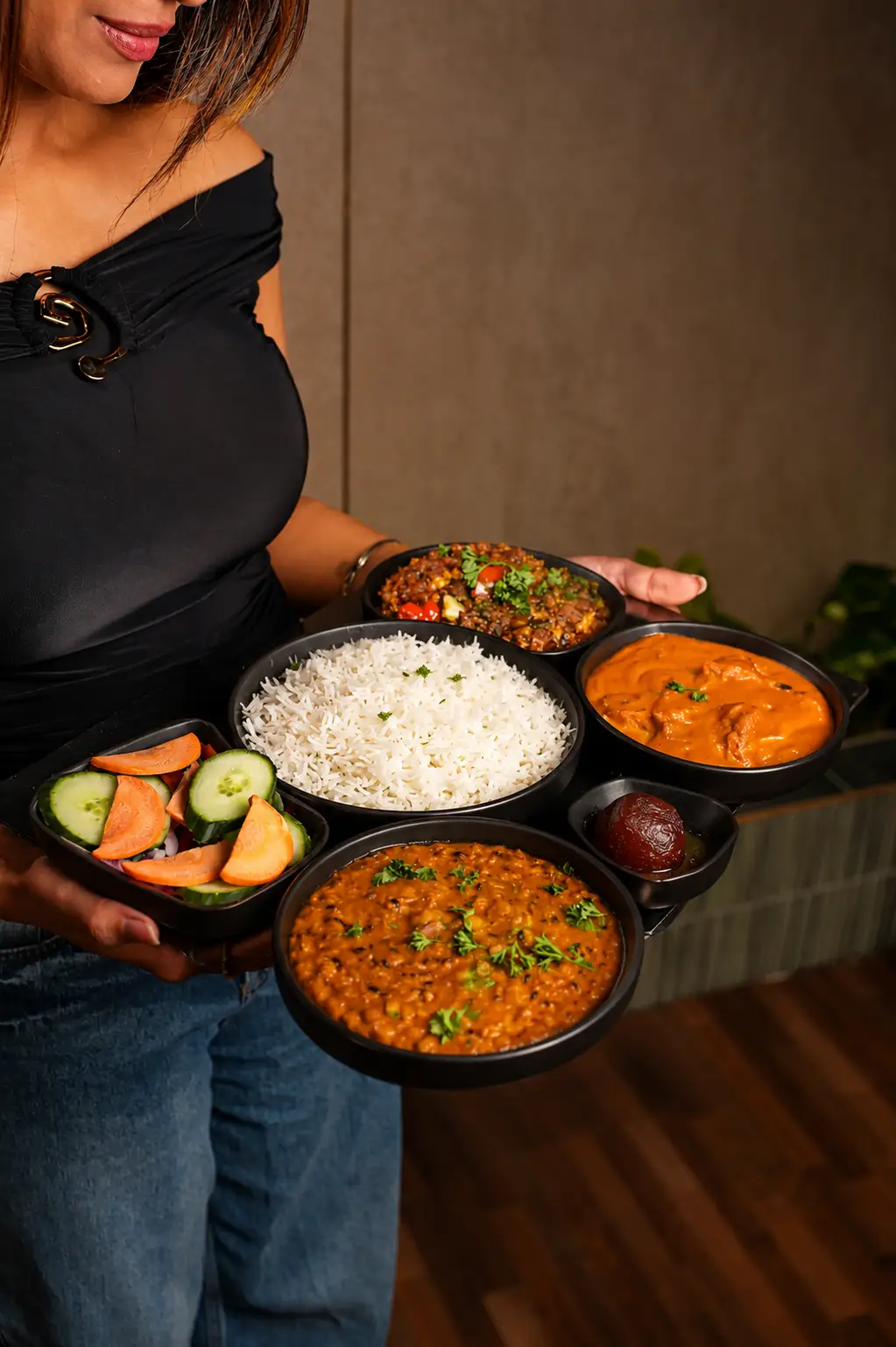 Delicious Indian Thali platter with rice, dal, curries, salad, and a sweet