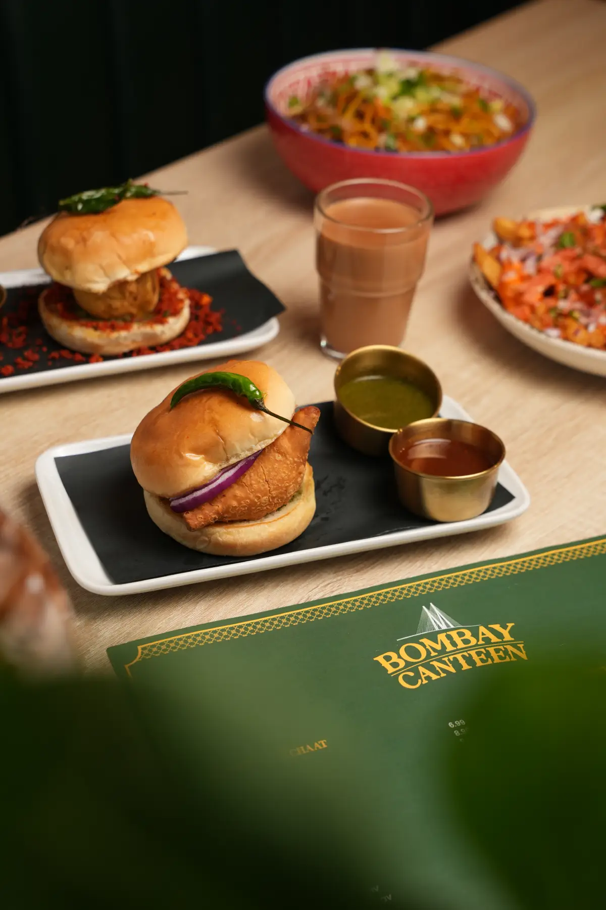 Authentic Mumbai style Vada Pav served with chutneys and hot chai tea